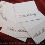 A stack of elegant place cards adorned with beautiful calligraphy, exuding sophistication and charm. Perfect for any occasion. Calligraphy by Jagdeep Sahans of Soul Scribe Calligraphy.