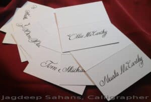 A stack of elegant place cards adorned with beautiful calligraphy, exuding sophistication and charm. Perfect for any occasion. Calligraphy by Jagdeep Sahans of Soul Scribe Calligraphy.