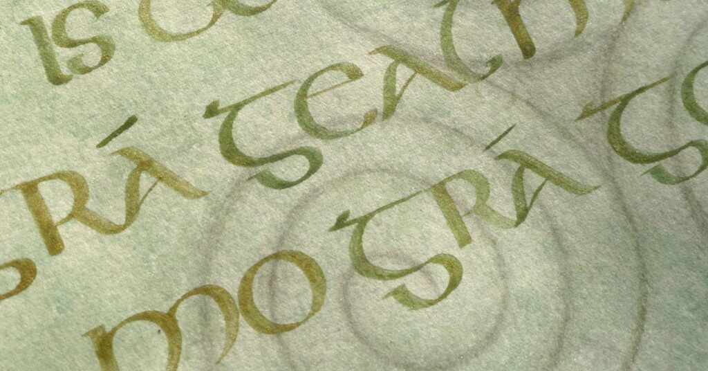 Close up of background of a unique calligraphy gift showing lettering style and a segment of the triple spiral. 