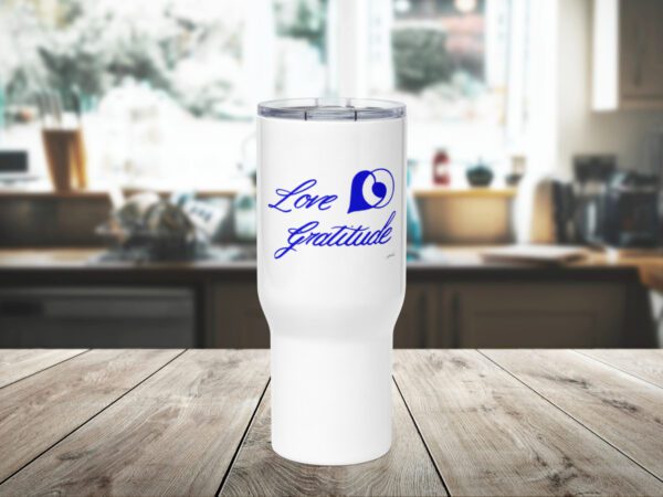 An image of a travel mug with handles showcases a design by Jagdeep Sahans that combines the symbols of love and gratitude, creating a visually appealing and unique travel accessory.